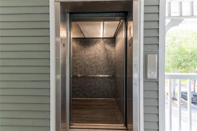 room details featuring wood walls and elevator