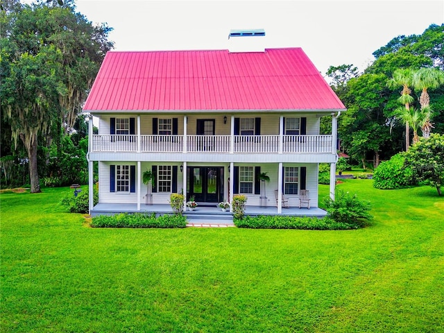 view of front of property with a balcony and a front yard