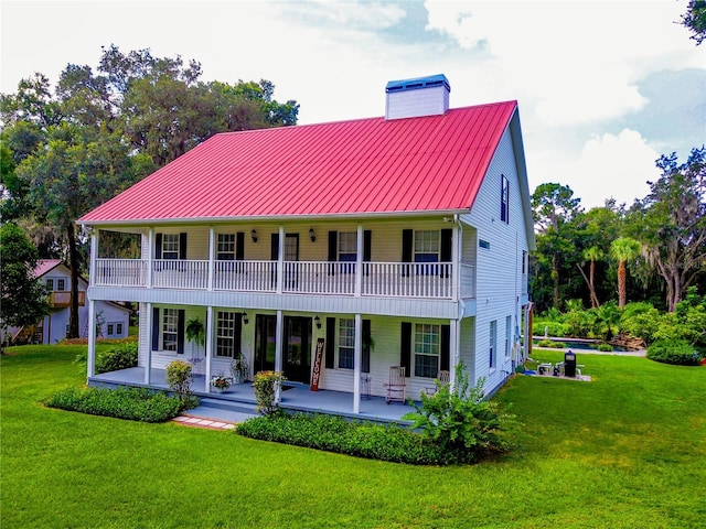 exterior space featuring a balcony and a yard