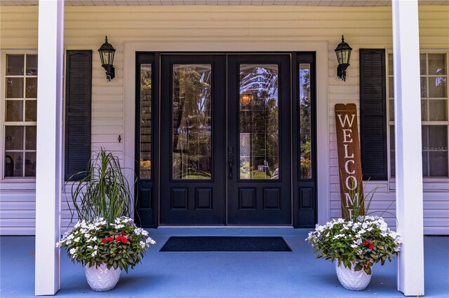 view of exterior entry with a porch