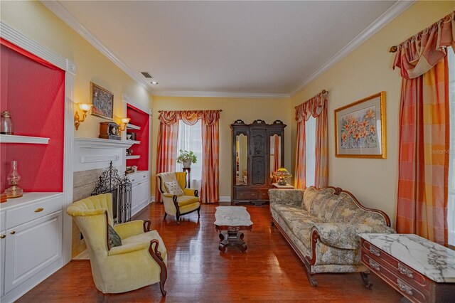 living room with ornamental molding, dark hardwood / wood-style flooring, and a fireplace