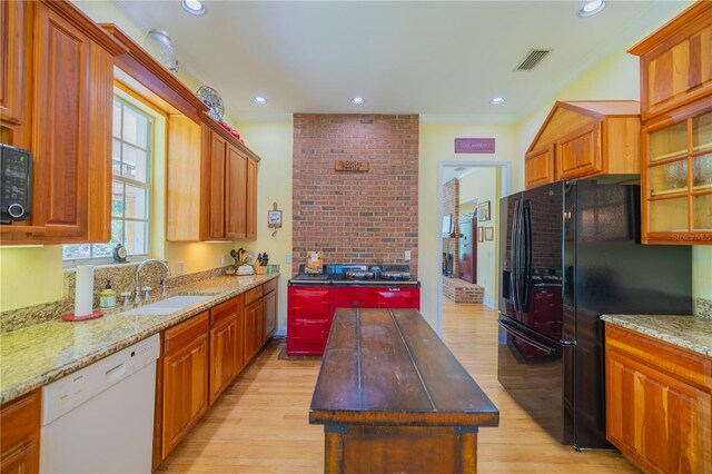 kitchen with sink, a center island, ornamental molding, light hardwood / wood-style floors, and black appliances