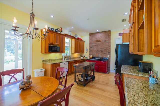 dining area featuring light hardwood / wood-style flooring, a chandelier, brick wall, sink, and crown molding