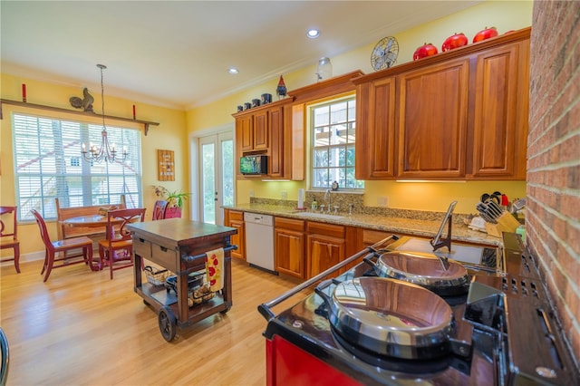 kitchen with sink, an inviting chandelier, light hardwood / wood-style flooring, dishwasher, and hanging light fixtures