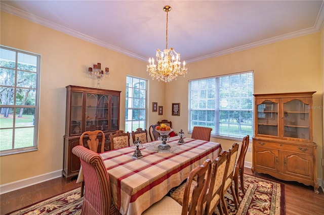 dining area with a wealth of natural light, hardwood / wood-style flooring, and a chandelier