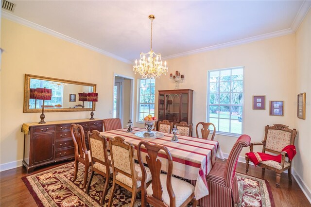 dining room with crown molding, an inviting chandelier, and dark hardwood / wood-style flooring