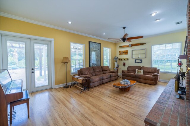 living room with ceiling fan, crown molding, french doors, and light hardwood / wood-style floors