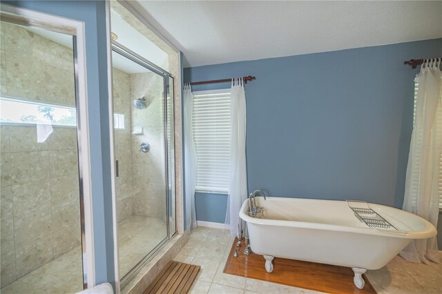 bathroom with tile patterned floors and separate shower and tub