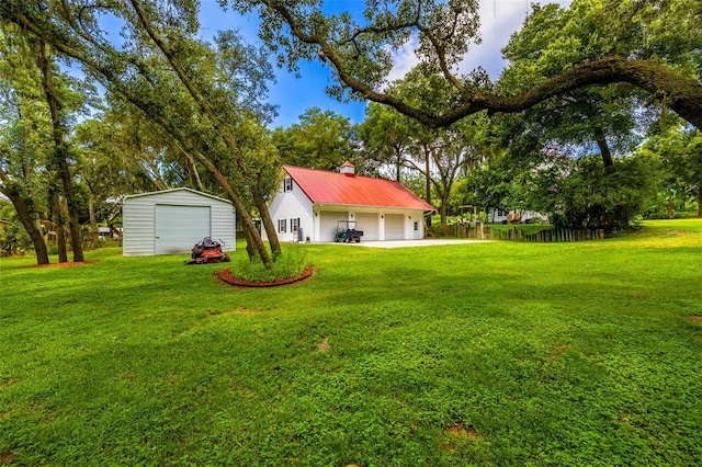 view of yard with a garage and an outdoor structure