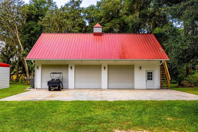 garage featuring a lawn