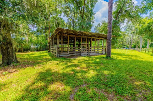 view of community with a yard and an outbuilding