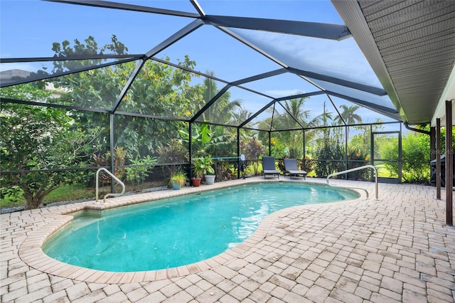 view of swimming pool featuring a patio area and a lanai