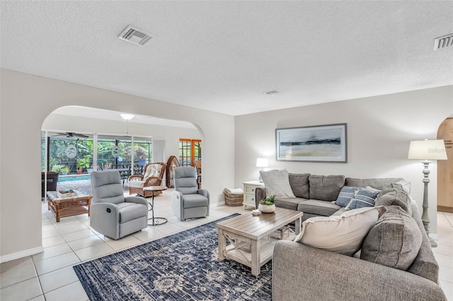 living room featuring light tile patterned floors and a textured ceiling