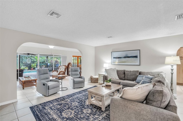 living room featuring light tile patterned flooring and a textured ceiling