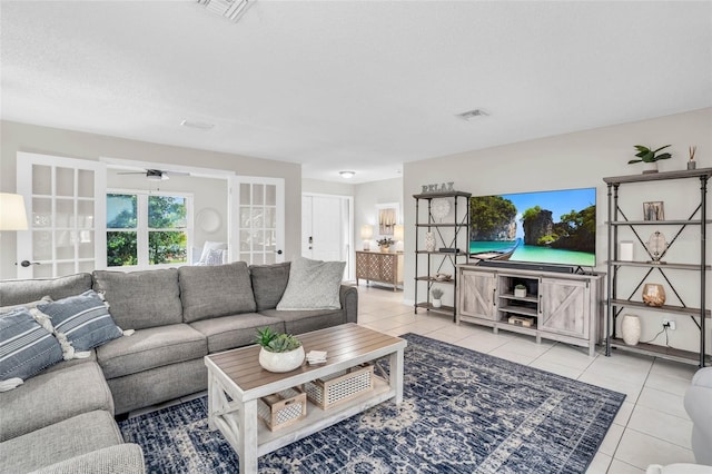 living room with light tile patterned floors, a textured ceiling, french doors, and ceiling fan