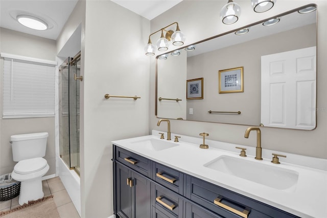 full bathroom featuring enclosed tub / shower combo, vanity, tile patterned floors, and toilet