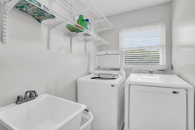 laundry area featuring sink and washing machine and clothes dryer