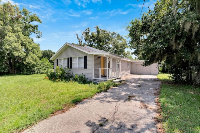 view of front of house with a front lawn, aphalt driveway, and covered porch