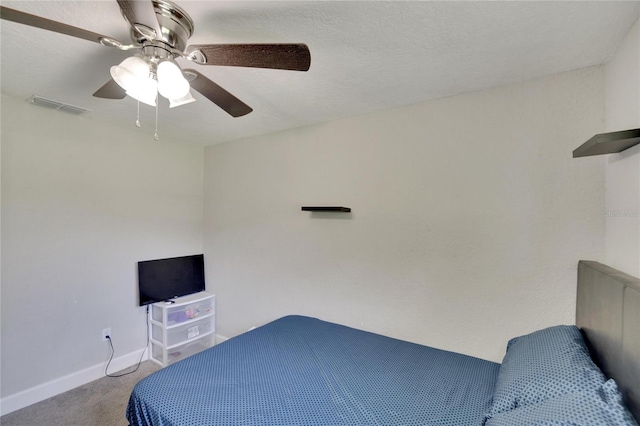 bedroom with visible vents, carpet flooring, baseboards, and a ceiling fan
