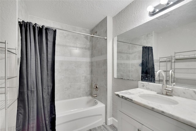 bathroom with vanity, shower / bathtub combination with curtain, and a textured ceiling