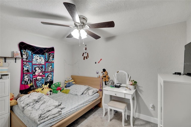 bedroom with ceiling fan, a textured ceiling, and light colored carpet