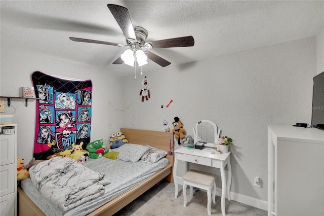 bedroom featuring light carpet, a ceiling fan, baseboards, and a textured ceiling