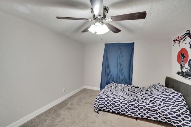 carpeted bedroom featuring a textured ceiling and ceiling fan