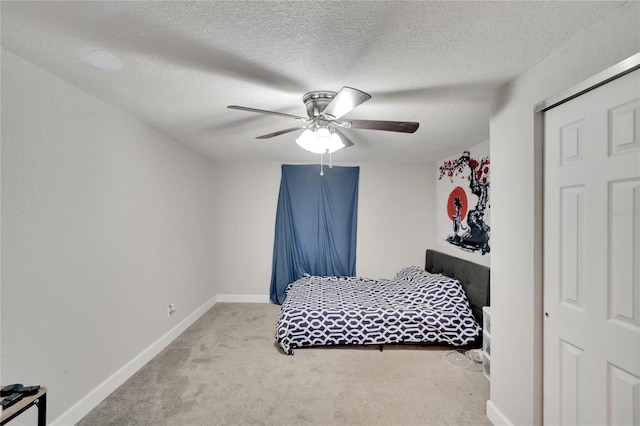 carpeted bedroom featuring a textured ceiling, baseboards, and ceiling fan