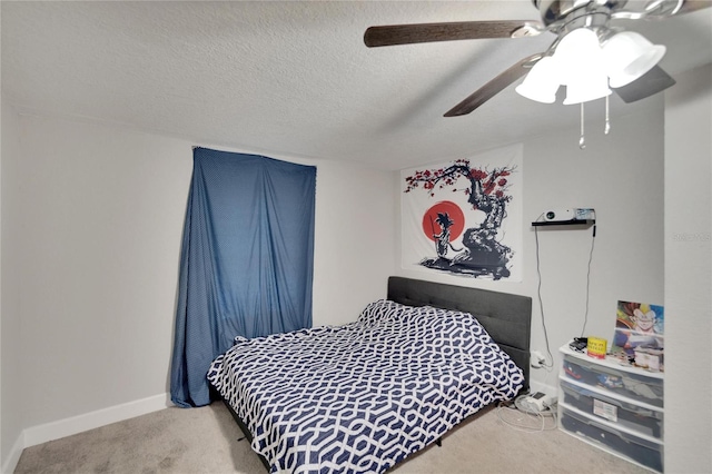 carpeted bedroom featuring ceiling fan and a textured ceiling