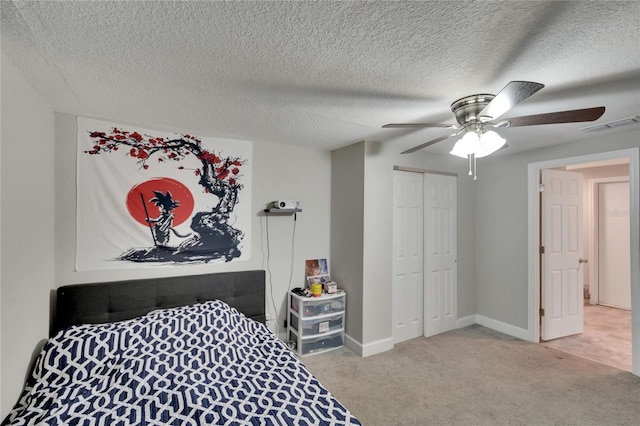 bedroom with light carpet, a textured ceiling, a closet, and ceiling fan