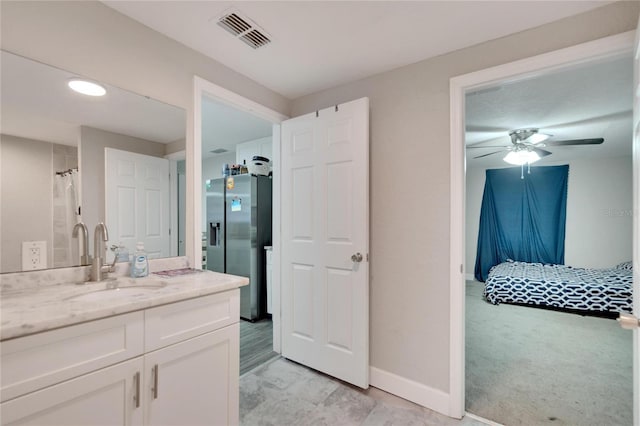 full bath with baseboards, a ceiling fan, vanity, and visible vents