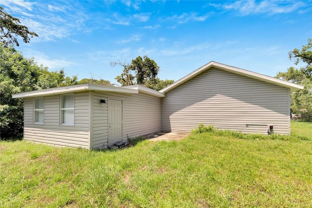 back of house with a lawn