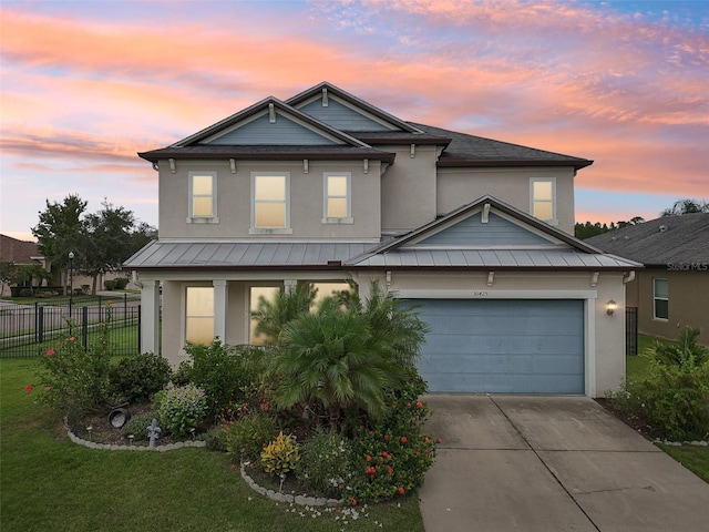 view of front of house featuring a lawn and a garage