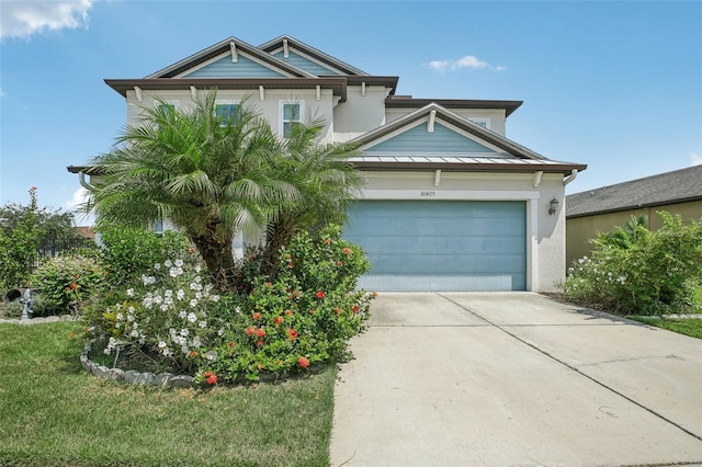 view of front of house with a garage and a front lawn