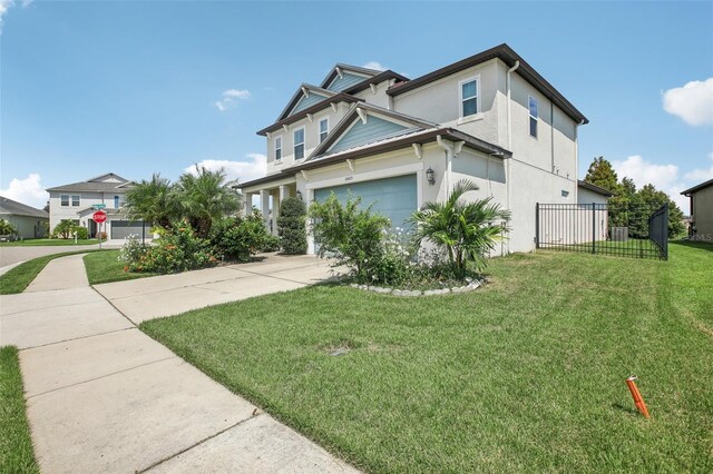 view of front of home featuring a front yard and a garage