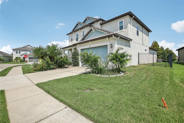 view of side of property featuring stucco siding, driveway, fence, a yard, and an attached garage