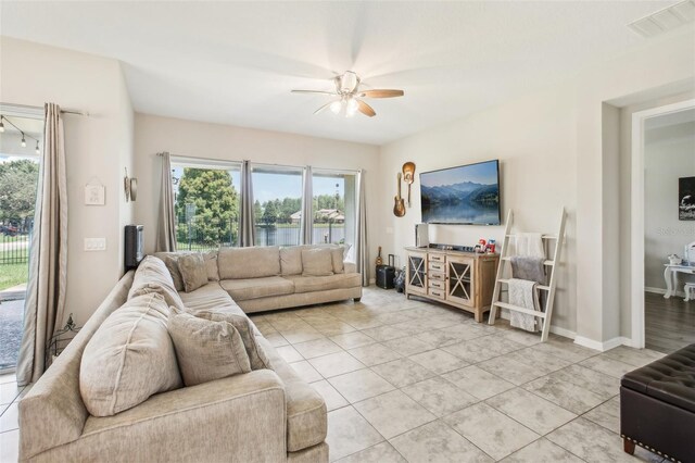 tiled living room with ceiling fan