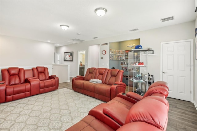 living area featuring wood finished floors and visible vents