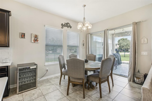 dining area featuring a wealth of natural light, a notable chandelier, beverage cooler, and light tile patterned floors