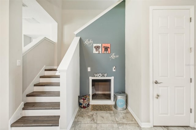 staircase featuring tile patterned flooring