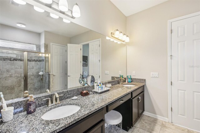 bathroom featuring tile patterned flooring, vanity, and an enclosed shower