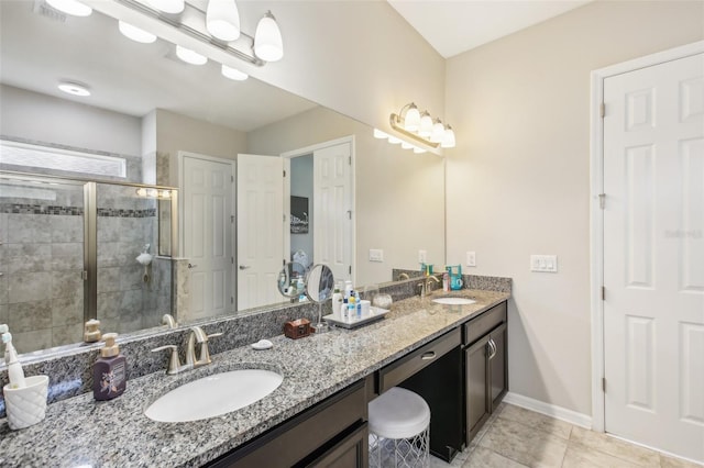 full bath with double vanity, visible vents, a stall shower, and a sink