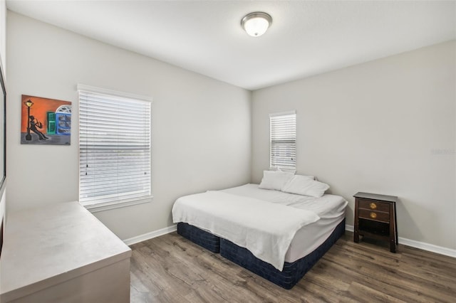 bedroom featuring baseboards and wood finished floors