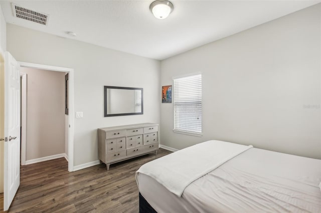 bedroom with dark wood-type flooring