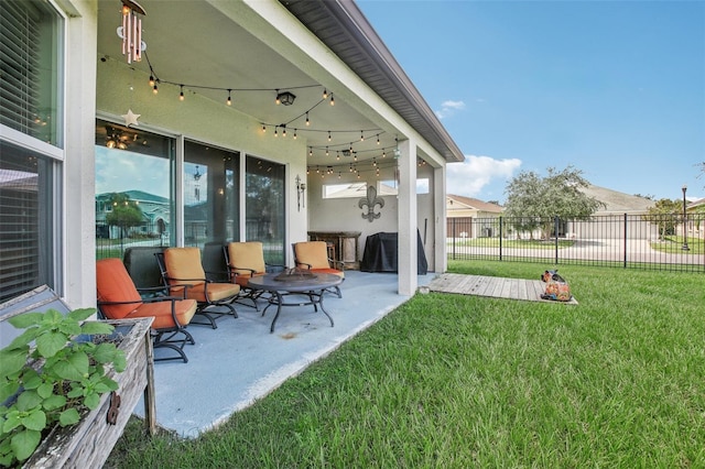 view of patio / terrace with a grill and fence