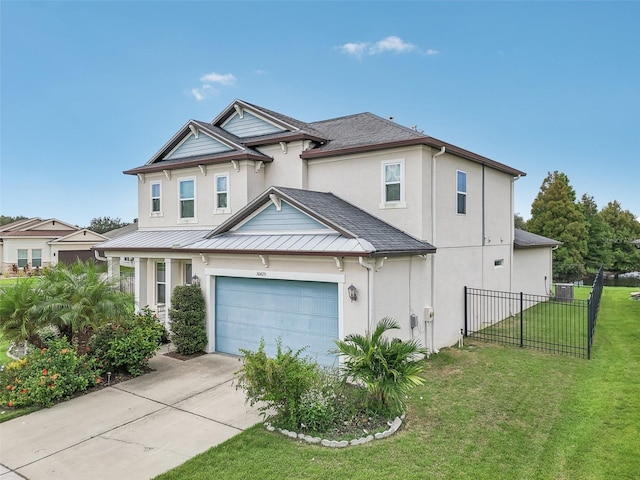 view of front of property with driveway, a front lawn, fence, a shingled roof, and a garage