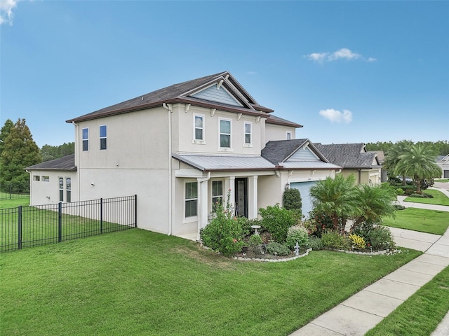 view of front facade featuring stucco siding, fence, metal roof, a front yard, and a garage