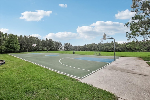 view of basketball court with a lawn