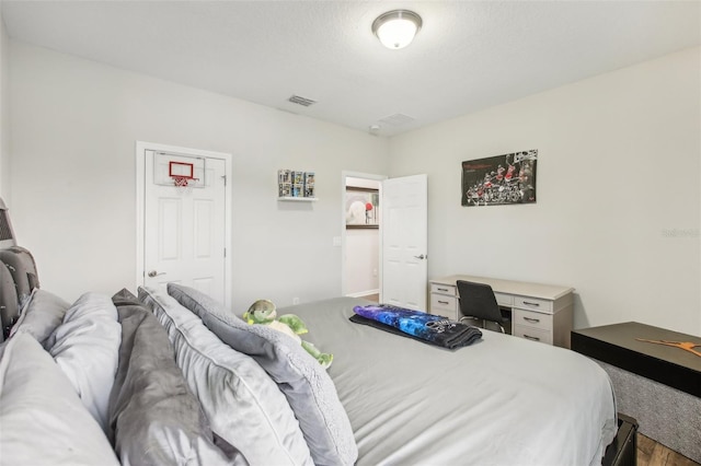 bedroom with wood-type flooring