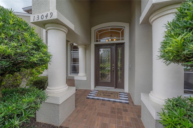 property entrance featuring stucco siding